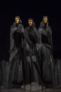 Low angle view of statue against black background