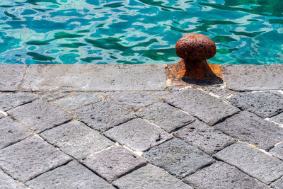 High angle view of stone wall by swimming pool