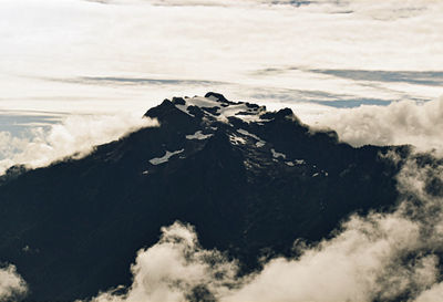 Scenic view of sea and mountains against sky