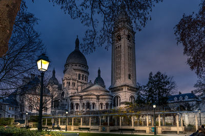 Low angle view of illuminated building against sky