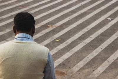 Rear view of man standing on road