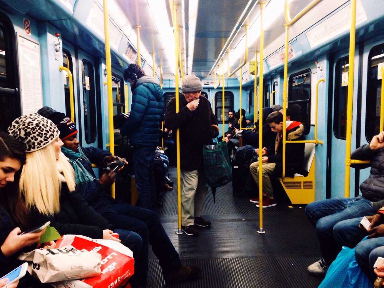 indoors, men, transportation, lifestyles, mode of transport, person, public transportation, sitting, vehicle seat, passenger, vehicle interior, leisure activity, travel, medium group of people, bus, journey, rear view