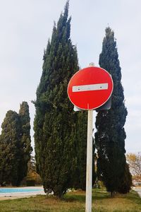 Road sign against sky