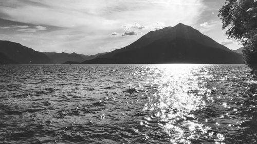 Scenic view of sea and mountains against sky