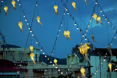 Low angle view of illuminated ferris wheel at night