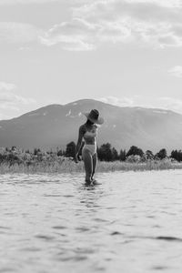 Full length of woman in front of mountain against sky