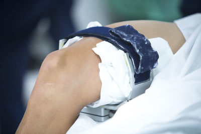 Close-up of medical equipment and bandages attached on human leg in operating room