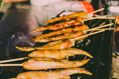 Close-up of meat on barbecue at night