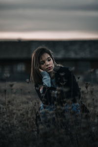 Young woman amidst plants during winter