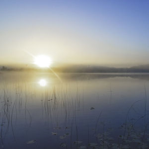 Scenic view of lake against sky during sunset