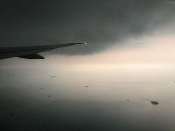 Airplane flying above clouds in sky