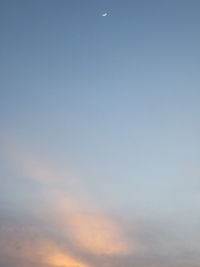 Low angle view of moon at sunset