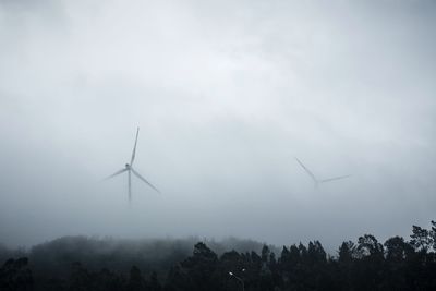 Low angle view of windmill against sky