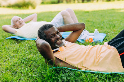 Rear view of man lying down on land