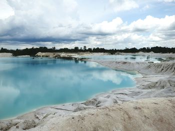 Scenic view of lake against cloudy sky