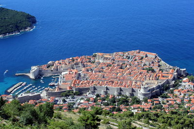 Aerial view of city by blue sea