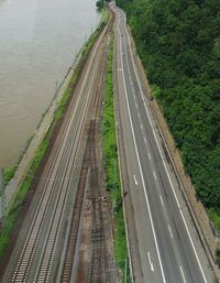 Empty road with rail tracks at riverbank
