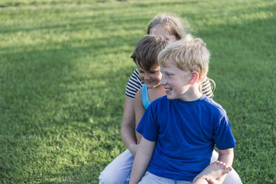 Boy sitting on grass