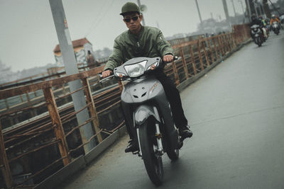Man riding motorcycle on city street
