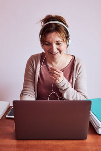 Woman working talking doing her job remotely during video chat phone call on laptop from home