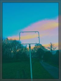 Silhouette of basketball hoop against sky during sunset