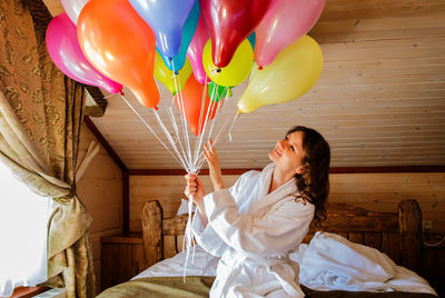 Birthday girl with ballons and champagne in morning