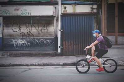 Man riding bicycle on street