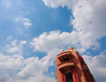 Low angle view of building against cloudy sky