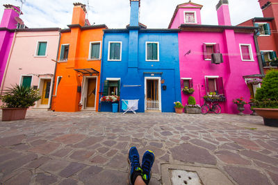 Low section of man against multi colored building