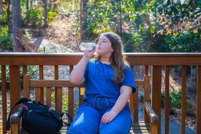 Young woman sitting on bench