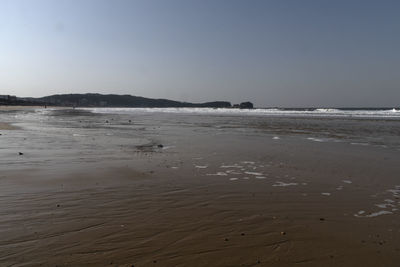 Scenic view of beach against clear sky