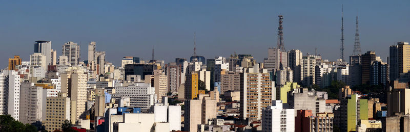 Aerial view of modern buildings in city against clear sky