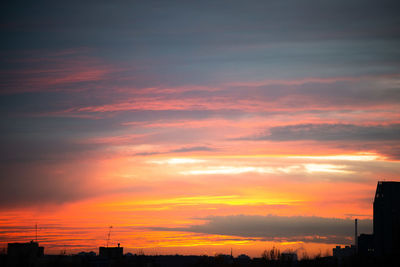 Silhouette buildings against sky during sunset