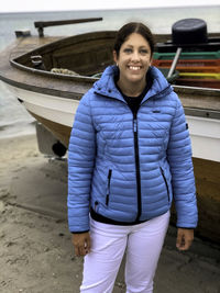 Portrait of smiling young man standing on boat