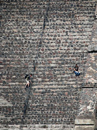 Man and woman climbing on wall