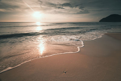 Scenic view of beach against sky during sunset