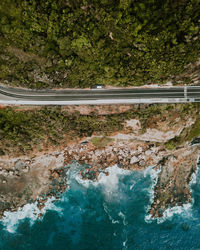 Aerial view of road by sea