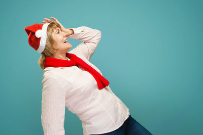 Midsection of woman standing against red background