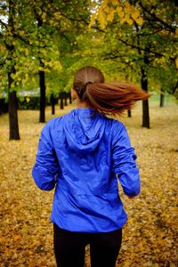 Rear view of woman standing on tree