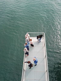 High angle view of people sitting by sea