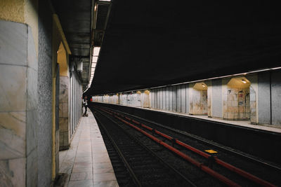 Railway tracks at railroad station at night