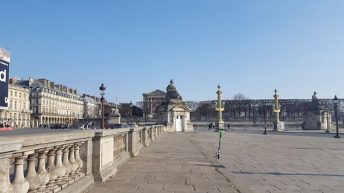 Buildings in city against clear blue sky