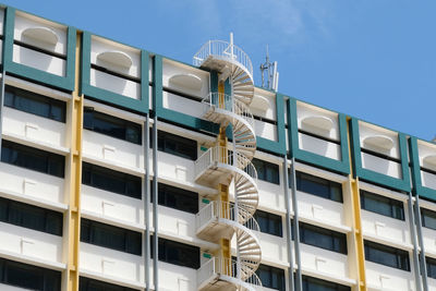 Low angle view of fire escape on building against sky