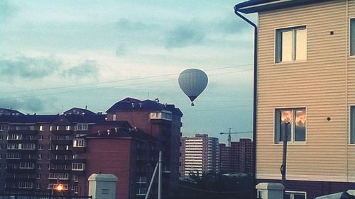 High section of buildings against cloudy sky