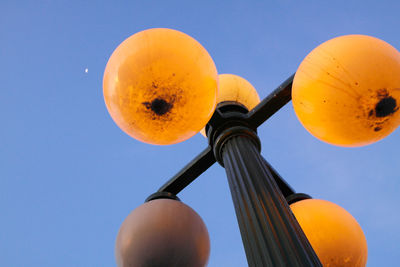 Low angle view of yellow lights against clear sky