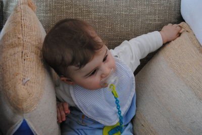 High angle view of cute baby relaxing at home