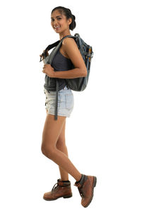 Portrait of young woman standing against white background