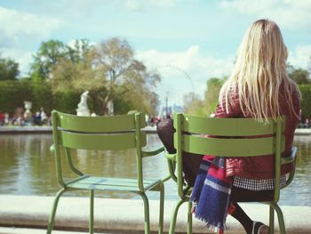 Rear view of woman sitting in park