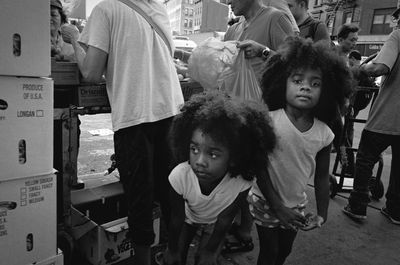 Portrait of siblings standing at market