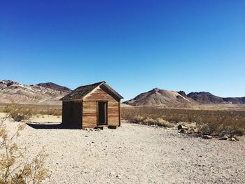 Built structure on desert against clear blue sky